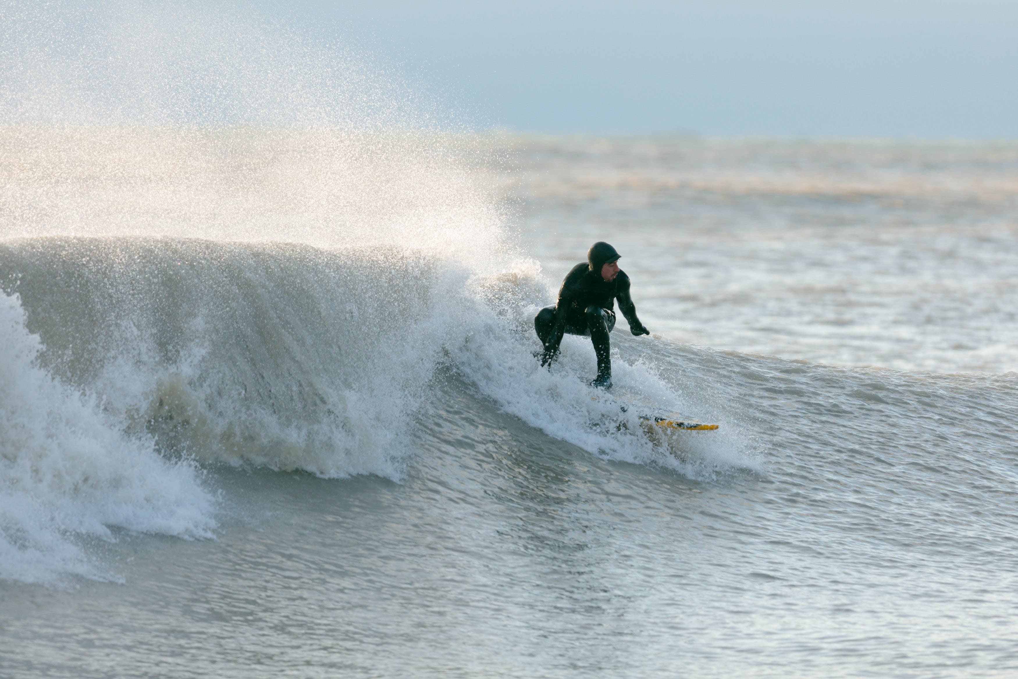 Surfer riding a wave on Lake Michigan